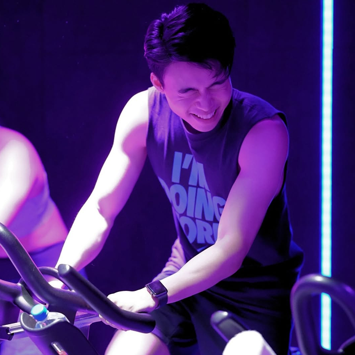 man at spin class at absolute boutique fitness studio hong kong